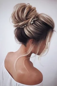 07 a voluminous and textural top knot with a bump some locks down and a couple of thinestone hairpieces