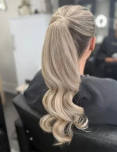 1 1. slick back low ponytail with soft waves