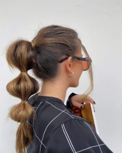 15. soft bubble ponytail with warm brunette dimension bubble ponytail