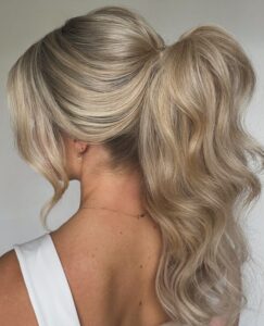 elegant voluminous high ponytail with soft waves for weddings proms events