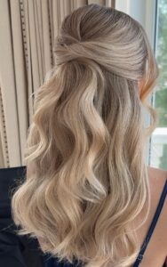romantic half up half down hairstyle with soft neutral blonde tones