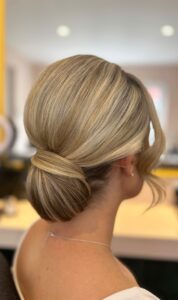 sleek low bridal bun with soft face framing pieces