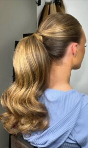 sleek low ponytail with soft waves for elegant events