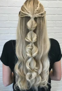 a half updo with six braids on top and a bubble ponytail plus waves down is a creative hairstyle for long hair it looks like no other