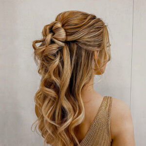 medium length wavy hair on a romantic half up hairstyle for prom