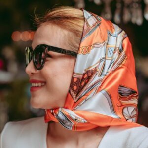 model wearing a silk scarf styled in her hair