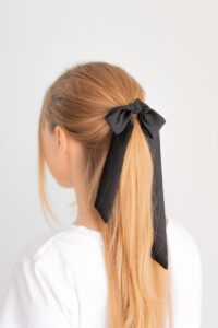 high ponytail with a bow or ribbon